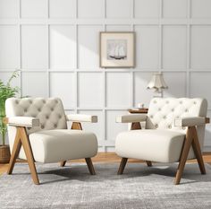 two white chairs sitting next to each other on top of a carpeted floor in front of a wall