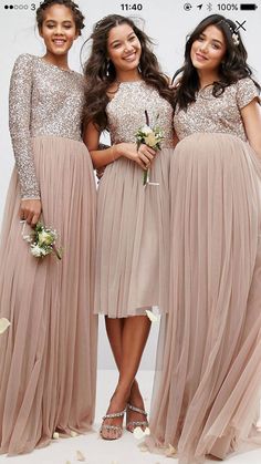 three bridesmaids pose for the camera in their dresses