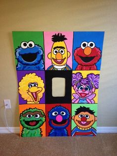 the sesame street gang light switch cover is made out of cardboard and painted with different colors