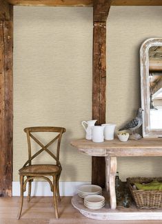 a wooden table sitting next to a mirror on top of a hard wood floor covered in dishes and cups