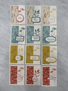 four cards with different designs on them sitting on a marble counter top next to each other