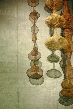 several different colored vases hanging from the ceiling