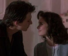 the young man and woman are looking into each other's eyes in this scene