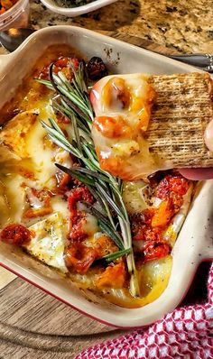 a casserole dish with cheese and vegetables in it