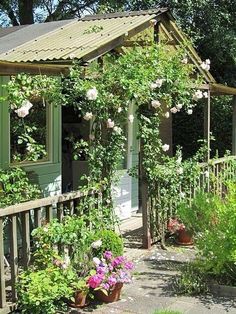 a house with lots of flowers growing on it