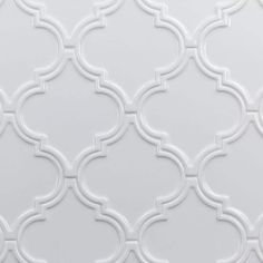 a white wall with an intricate pattern on it