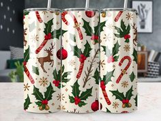 two christmas themed can coolers sitting on top of a counter