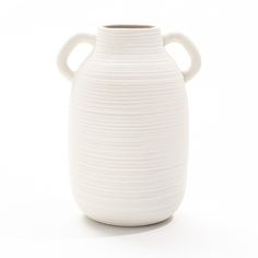 a large white vase with two handles on the top and bottom, sitting in front of a white background