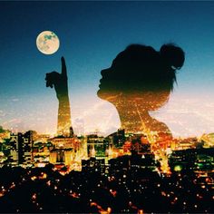 the silhouette of a woman is shown in front of a cityscape at night