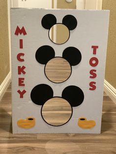 a cardboard mickey mouse sign on the floor