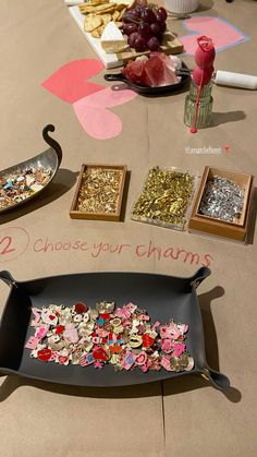 there are two trays on the table with different types of confetti in them