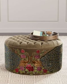 a round ottoman with flowers on it