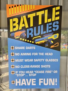 a sign that is on the side of a window saying, battle rules no aiming for the head must wear safety glasses not close range shots