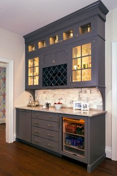 a kitchen with gray cabinets and white counter tops, is featured on pinterest