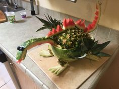 a dragon made out of watermelon sitting on top of a counter