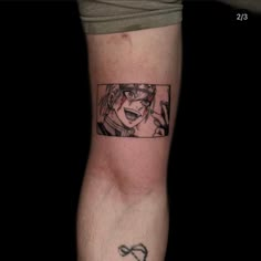 a man with a tattoo on his arm that has an anime character in the background