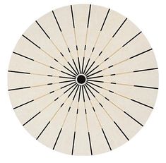 a white rug with black lines in the shape of a sunburst on it