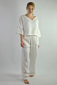 "This is our no. 57 of Conscious Clothing Concept. This pyjama has modern style which makes it a very versatile to wear not only in bed or around the house but you can wear it out on the sunny day with some accesories. The trousers are lose and comfy fit with elasticated waist and two pockets. The top is beautifully simple with pleats on the sleeves which makes it very feminine. This set is made of high quality pure white linen. It is the ultimate fabric for hot weather as it breathes and absorb White Linen Lounging Bottoms, Relaxed Fit Sets For Summer Relaxation, White Linen Bottoms For Relaxation, White Linen Casual Sets, White Summer Relaxation Sets, Summer Relaxation White Sets, Casual Linen Beachwear Set, Casual Linen Beach Set, Casual Linen Sets For Vacation