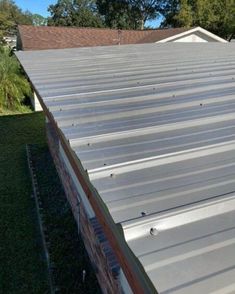 the roof of a house that has been painted silver and is in need of repair