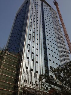 a tall building with lots of windows under construction