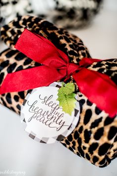 a close up of a stuffed animal with a red ribbon