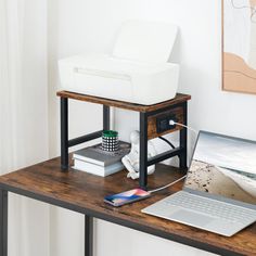 a laptop computer sitting on top of a wooden desk next to a printer and scanner