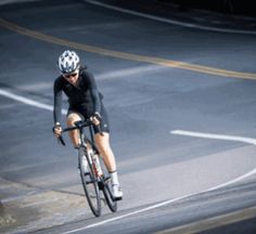 a man riding a bike down a curvy road