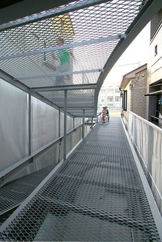 the walkway is made of metal and has a perfored covering over it's sides