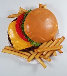 a cheeseburger and fries on a white plate