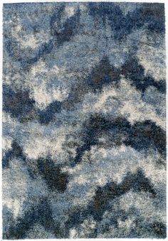 a blue and white rug with clouds on it