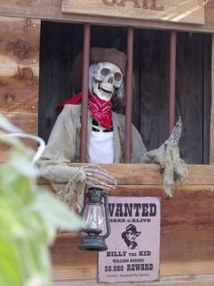 a skeleton in a jail cell wearing a hat and scarf