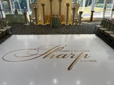 a large white dance floor with the word happy on it in gold and silver lettering