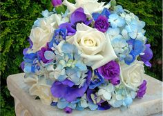 a bridal bouquet with blue and white flowers