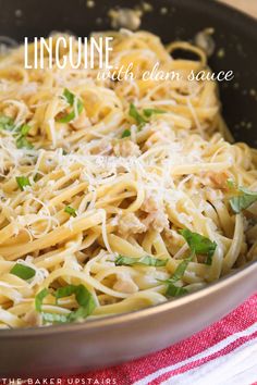 linguine with clam sauce in a pan on a red and white towel