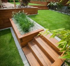 a wooden bench sitting on top of a lush green field