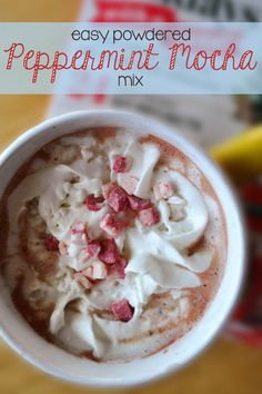 a cup of peppermint mocha with whipped cream and pink sprinkles