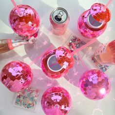 several pink objects are arranged on a table with confetti and glitter around them