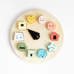 a wooden clock with different shapes and colors