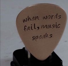 a guitar pick that says when words fail, music speaks