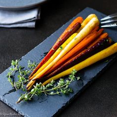 a bunch of carrots sitting on top of a blue plate