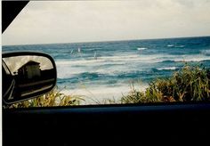 the view from inside a car looking out at an ocean