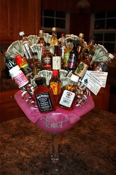 a pink vase filled with lots of liquor