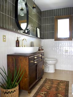 a bathroom with a sink, toilet and rug