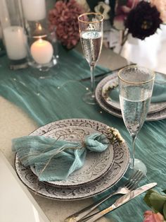 the table is set with silverware and place settings