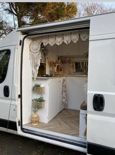 an open van door showing the kitchen area