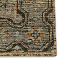 an old rug is shown on a white background with blue and yellow accents, including a design in the middle