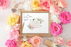 pink and yellow flowers surrounding a gold frame on a white surface with a message in the middle