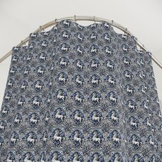 a blue and white curtain with horses on it