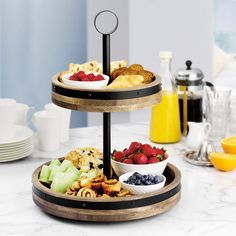 three tiered trays filled with fruit and pastries