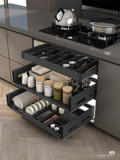 an open drawer in the middle of a kitchen